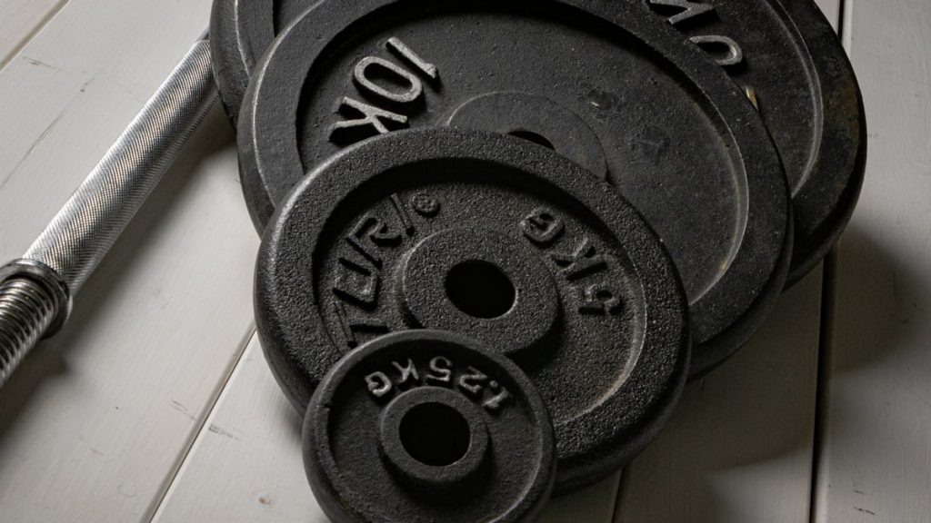 Weight plates and barbell setup for strength training at home. Fitness gear I would use → linktr.ee/alexsaks.inspiration